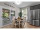 Bright dining area features wood floors, a table for four, and sliding doors to an outdoor patio at 648 Long Melford Dr, Rolesville, NC 27571