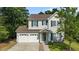 Charming two-story home with a well-manicured lawn, two-car garage, and inviting front porch at 648 Long Melford Dr, Rolesville, NC 27571