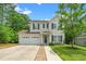 Charming two-story home with a well-manicured lawn, two-car garage, and inviting front porch at 648 Long Melford Dr, Rolesville, NC 27571