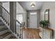 Welcoming foyer with hardwood floors, a staircase, and a white front door at 648 Long Melford Dr, Rolesville, NC 27571