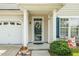 Welcoming front entrance with a decorated door, white columns, and manicured landscaping at 648 Long Melford Dr, Rolesville, NC 27571