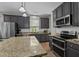 Well-equipped kitchen with granite counters, gray cabinets, stainless steel appliances, and an island at 648 Long Melford Dr, Rolesville, NC 27571