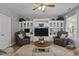 Inviting living room with a ceiling fan, built-in shelves, and comfortable seating at 648 Long Melford Dr, Rolesville, NC 27571