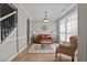 Comfortable living room featuring a leather sofa, patterned chair, and bright natural light at 648 Long Melford Dr, Rolesville, NC 27571