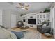 Cozy living area featuring a ceiling fan, built-in shelving, and comfortable seating at 648 Long Melford Dr, Rolesville, NC 27571