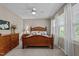 Comfortable main bedroom featuring a wooden bed, large windows, and a dresser at 648 Long Melford Dr, Rolesville, NC 27571