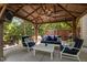 Inviting covered patio with comfortable seating, a ceiling fan, and an outdoor television for entertainment at 648 Long Melford Dr, Rolesville, NC 27571