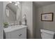 Elegant powder room with marble countertop, decorative mirror, and stylish fixtures at 648 Long Melford Dr, Rolesville, NC 27571