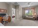 Inviting sitting room features a cozy couch, desk space, and natural light from the large window at 648 Long Melford Dr, Rolesville, NC 27571