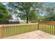 Inviting wooden deck with railing overlooking a spacious lawn and mature trees at 71 E Boxley Dr, Wendell, NC 27591