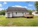 Backyard featuring a lawn, mature trees, rear entry door, and wooden deck attached to the house at 71 E Boxley Dr, Wendell, NC 27591