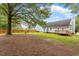 Spacious backyard with mature trees, lush lawn, and wood deck at 71 E Boxley Dr, Wendell, NC 27591