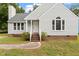Attractive single-Gathering home featuring gray siding, classic windows and an inviting brick-lined entrance at 71 E Boxley Dr, Wendell, NC 27591