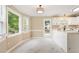 Bright eat-in kitchen featuring white cabinets, white countertops, and marble-look tile flooring at 71 E Boxley Dr, Wendell, NC 27591