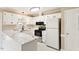 Bright kitchen with white cabinets, marble countertops, and stainless steel appliances at 71 E Boxley Dr, Wendell, NC 27591