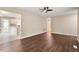 Open-concept living room featuring wood floors that connect to a bright, updated kitchen at 71 E Boxley Dr, Wendell, NC 27591