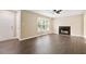 Inviting living room with wood flooring, fireplace, ceiling fan, and abundant natural light at 71 E Boxley Dr, Wendell, NC 27591