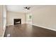 Spacious living room featuring wood floors, a cozy fireplace, and ample natural light at 71 E Boxley Dr, Wendell, NC 27591