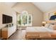 Light-filled main bedroom with vaulted ceiling, large windows, and stylish furnishings at 71 E Boxley Dr, Wendell, NC 27591