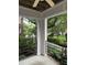 Comfortable covered balcony with a ceiling fan, black iron railing, and views of the landscaped yard at 710 N Person St # 103, Raleigh, NC 27604