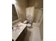 Bathroom features a vanity with a sink, a toilet, and a shower with a floral curtain at 710 N Person St # 103, Raleigh, NC 27604
