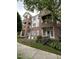 Three-story brick condo building with balconies and beautiful landscaping near sidewalks and lawn at 710 N Person St # 103, Raleigh, NC 27604