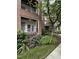Brick condo exterior features colorful hydrangeas, lawn, sidewalk, porch, and black railing at 710 N Person St # 103, Raleigh, NC 27604