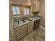 Clean kitchen with stainless steel sink, dishwasher and wooden cabinets, with an open view to the living room at 710 N Person St # 103, Raleigh, NC 27604