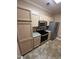 Well-equipped kitchen features stainless steel appliances, wooden cabinets, and granite counters at 710 N Person St # 103, Raleigh, NC 27604