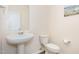Clean, well-lit half bathroom featuring a pedestal sink and toilet at 728 Silo Park Dr, Wake Forest, NC 27587