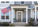 Inviting covered front porch with seating offering a warm welcome to the neutral-tone home at 728 Silo Park Dr, Wake Forest, NC 27587