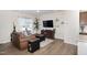 Bright living room with wood floors and a view of the front yard, showcasing modern design at 728 Silo Park Dr, Wake Forest, NC 27587