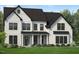 Charming two-story home features a covered entry, black framed windows, and a beautifully landscaped front yard at 805 Timber Mist Ct, Cary, NC 27519