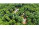 Aerial view of the property showcasing a tennis court, well-manicured grounds, and wooded surroundings at 812 Kenmore Rd, Chapel Hill, NC 27514