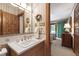 Well-lit bathroom featuring a white vanity with gold fixtures and decorative accents at 812 Kenmore Rd, Chapel Hill, NC 27514