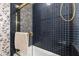 Shower with dark blue tile and gold hardware at 812 Kenmore Rd, Chapel Hill, NC 27514