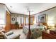 Comfortable bedroom showcases four poster bed, wood trim, and sunny windows at 812 Kenmore Rd, Chapel Hill, NC 27514