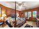 Bedroom with wood paneled walls, four poster bed and lots of natural light at 812 Kenmore Rd, Chapel Hill, NC 27514