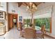 Eat-in breakfast nook with wood vaulted ceiling, large picture windows overlooking the wooded area and wicker furniture at 812 Kenmore Rd, Chapel Hill, NC 27514