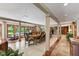 Open dining room with a long table, multiple chairs, marble floor and view to staircase at 812 Kenmore Rd, Chapel Hill, NC 27514