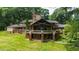 Scenic view of home with large windows, stone details, and verdant lawn at 812 Kenmore Rd, Chapel Hill, NC 27514