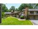 Stunning exterior of home with stone accents, lush lawn, and mature trees at 812 Kenmore Rd, Chapel Hill, NC 27514
