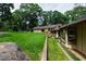 Beautiful backyard with a well-maintained lawn, stone wall, and mature trees at 812 Kenmore Rd, Chapel Hill, NC 27514