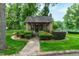 Charming cottage with a stone pathway, manicured bushes, and mature trees at 812 Kenmore Rd, Chapel Hill, NC 27514