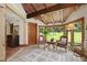 Hallway with vaulted wood ceiling, large windows overlooking the backyard and tile flooring at 812 Kenmore Rd, Chapel Hill, NC 27514