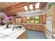 Bright kitchen featuring wood cabinets, white countertops, stainless appliances, skylights and views to the exterior at 812 Kenmore Rd, Chapel Hill, NC 27514