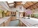 Bright kitchen featuring wood cabinets, white countertops, tile accents, skylights and views to the breakfast nook at 812 Kenmore Rd, Chapel Hill, NC 27514