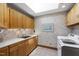 Functional laundry room with ample cabinetry, countertop space, and modern appliances at 812 Kenmore Rd, Chapel Hill, NC 27514