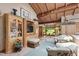 Bright living room with vaulted ceilings, wood beams, large windows overlooking the backyard and built in cabinets at 812 Kenmore Rd, Chapel Hill, NC 27514