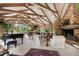 Bright living room with stone fireplace, white furniture, a grand piano, and scenic outdoor views at 812 Kenmore Rd, Chapel Hill, NC 27514